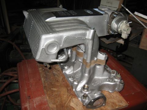 1994 Ford Bronco - A silver supercharger assembly with intake manifold is shown, not a complete vehicle.