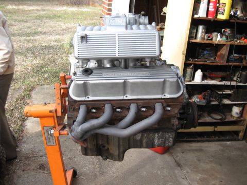1994 Ford Bronco - V8 engine on an engine stand, with exhaust manifolds and spark plugs visible.