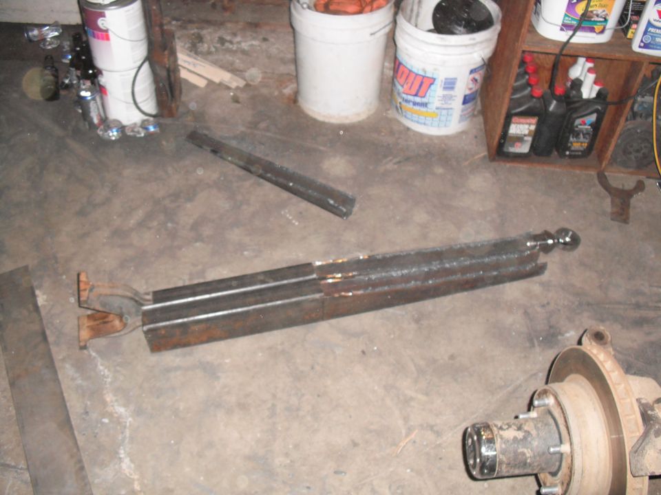 Welded steel fabrication parts and a vehicle hub assembly on a concrete floor
