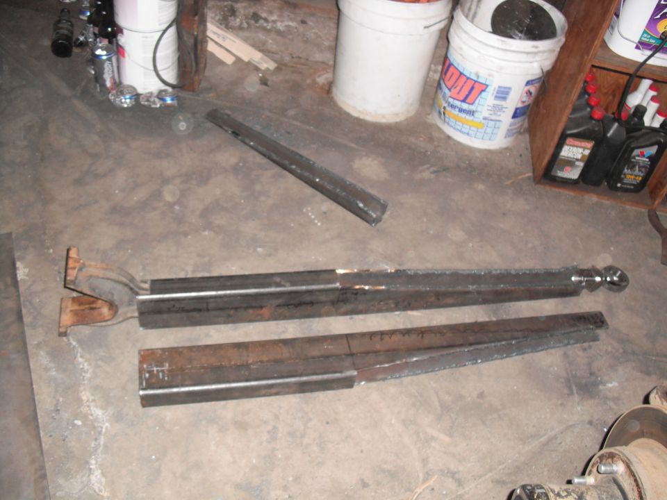 Fabricated metal radius arms on a concrete floor