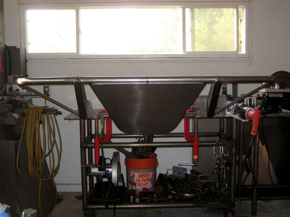 Custom metal bumper fabrication in progress, with welding clamps and tools
