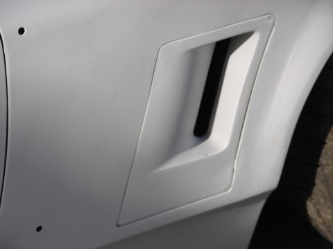 1973 Ford Ranchero - A detail shot of a car's side fender shows a prominent air vent.