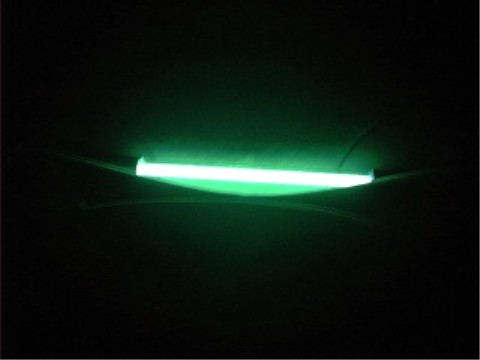 1997 Ford Taurus - A green neon light strip is visible mounted underneath a vehicle, casting a glow in the dark.