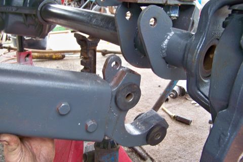 1989 Ford Bronco - Close-up view of vehicle axle and suspension parts, likely during a repair or modification process.