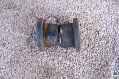 1989 Ford Bronco - A worn metal axle component is shown against a carpeted background, with a Supermotors logo visible.