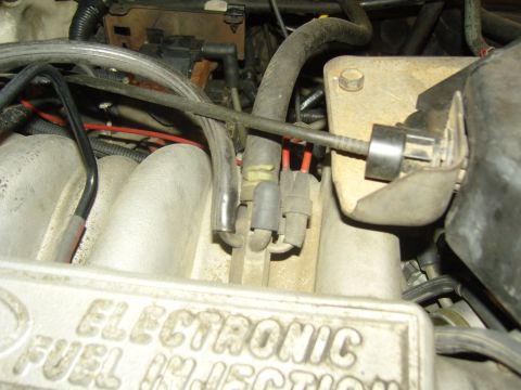 2007 Ford Mustang - Engine intake manifold showing 'ELECTRONIC FUEL INJECTION' text and various hoses and connectors.