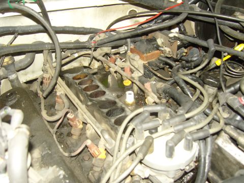 2007 Ford Mustang - Close-up view of an engine's intake manifold and fuel injectors during repair.