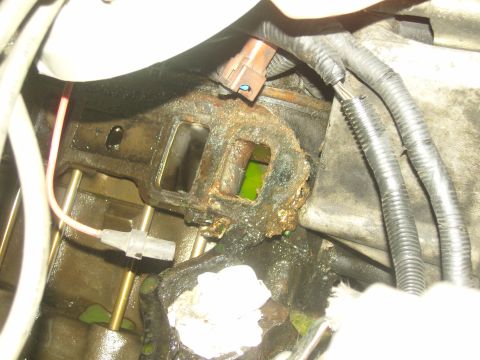 2007 Ford Mustang - A close-up view of a corroded engine intake manifold shows signs of a coolant leak.
