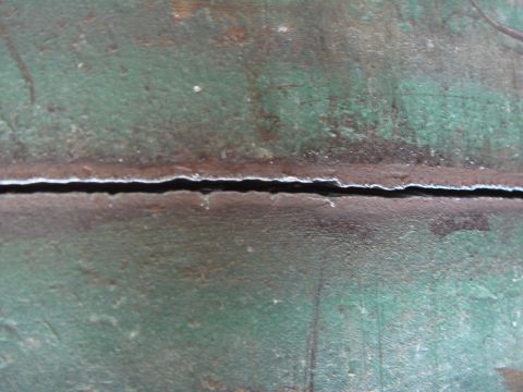 1992 Ford Bronco - A close-up view shows a significant crack on a weathered metal surface, with the Supermotors.net logo in the corner.