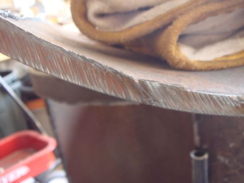 1992 Ford Bronco - A close-up view of a metal edge, possibly from a vehicle part, with a piece of fabric resting on top.