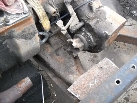 1954 Ford F-100 - Engine and transmission components are visible, along with parts of the vehicle's chassis.