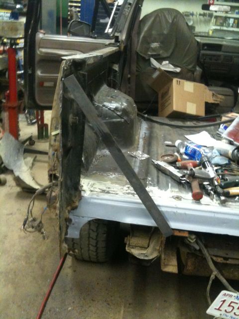 1993 Ford Bronco - Bodywork underway on a 1993 Ford Bronco, focusing on rust repair of the rear quarter panel.