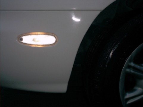1997 Ford Taurus - Close-up of a vehicle's side marker light and tire, with a watermark for Supermotors.net visible.