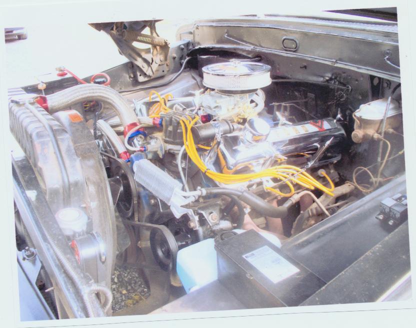 Engine bay showing V8 with chrome air cleaner, chrome valve covers, and yellow plug wires