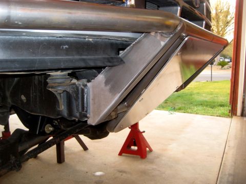 1996 Ford Bronco - Custom skid plate installation on a vehicle frame, supported by jack stands.