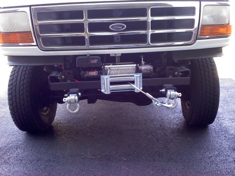 1996 Ford Bronco - This Ford truck features a winch and tow hooks on its front bumper, ready for off-road adventures.