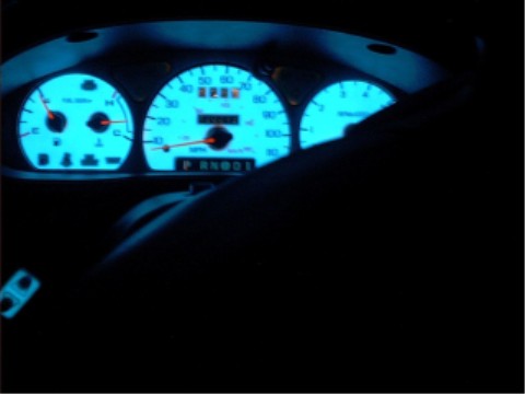 1997 Ford Taurus - The illuminated dashboard of a 1997 Ford Taurus shows glowing blue gauges and an odometer displaying 2285 miles.
