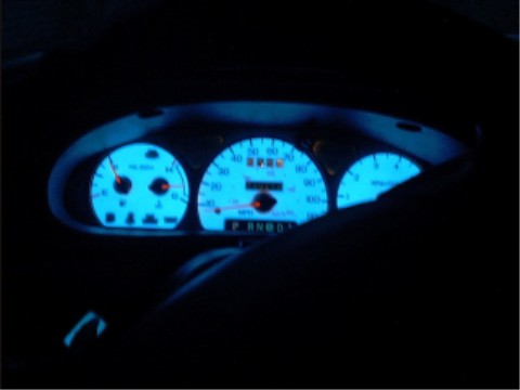 1997 Ford Taurus - Dashboard of a 1997 Ford Taurus showing illuminated gauges and gear selector.