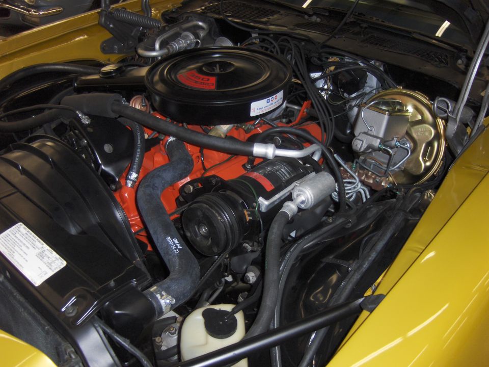 Yellow 1979 Chevrolet Camaro engine bay with V8 engine, air conditioning, and brake booster