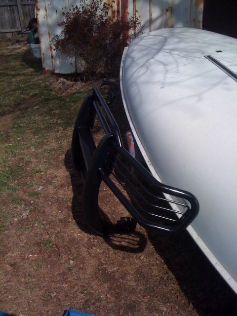 1995 Ford Bronco - A white Ford Bronco is parked outdoors, a black brush guard on its front end.