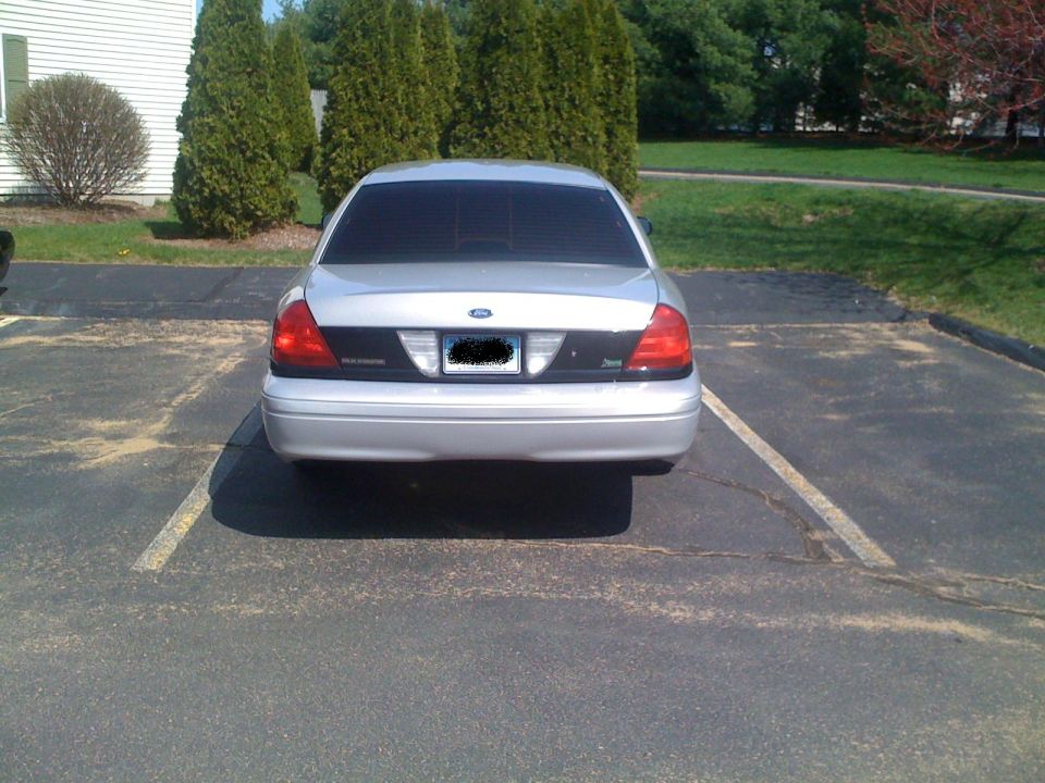 2009 Ford Crown Victoria parked in a lot, rear view