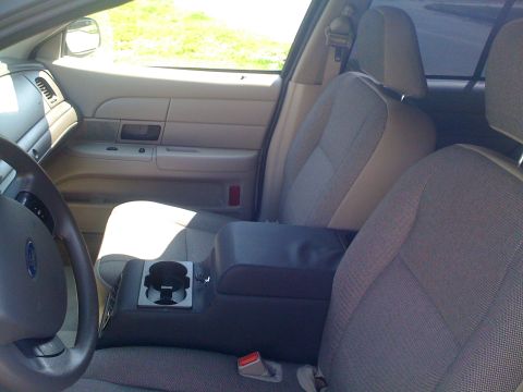 2009 Ford Crown Victoria - Interior view of a 2009 Ford Crown Victoria, highlighting the front seating area and dashboard details.