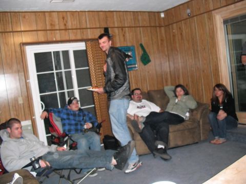 1991 Ford Bronco - People socializing in a room with wood paneling and a large window.