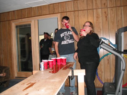 1991 Ford Bronco - A group of people are gathered around a table set up for a game of beer pong.