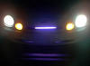 1997 Ford Taurus - The front of a vehicle is visible at night, with its headlights and amber parking lights illuminated against a dark background.