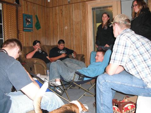 1991 Ford Bronco - People gathered in a room, some sitting on a couch and chairs, others standing.