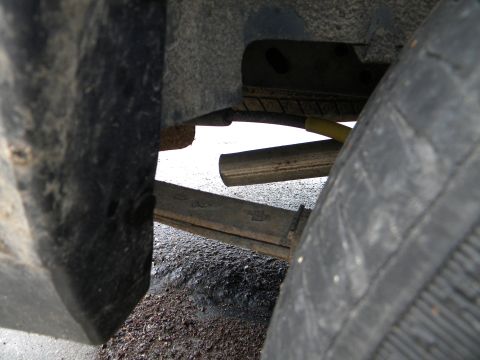 1993 Dodge Grand Caravan - Close-up view of a vehicle's rear suspension components and tire.