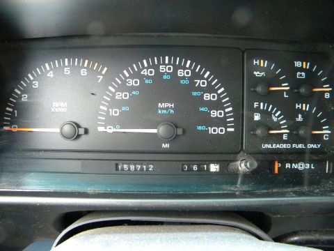 1993 Dodge Grand Caravan - The dashboard shows a speedometer, tachometer, fuel level, engine temperature, and an odometer reading of 158,712 miles.