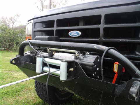 1994 Ford Bronco - Front view of a black 1994 Ford Bronco, a heavy-duty winch installed on the aftermarket bumper.