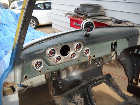 1954 Ford F-100 - Interior view of a 1954 Ford F-100 dashboard, multiple aftermarket gauges and a tachometer.