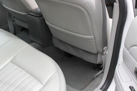 2003 Ford Crown Victoria - The interior of a car is shown, focusing on the rear seats and center console, with a visible watermark.