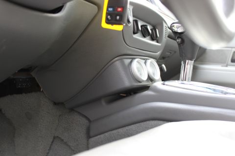 2003 Ford Crown Victoria - Interior view of a car's dashboard and center console, with aftermarket gauges installed.