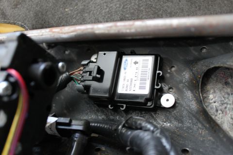2007 Ford Crown Victoria - this is the problem source, the 2003 LX restraint control module. drill out the two rivets and remove the module.