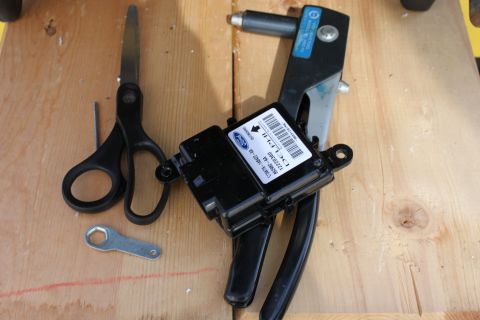 2007 Ford Crown Victoria - old 2003 restraint control module and some tools used. I had to drill out the rivits and re-rivit the 2007 module to the 2003 seat frame.