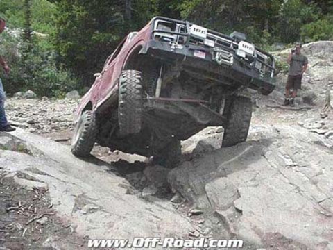 2002 Ford F-350 - Off-road truck navigating a difficult rocky terrain.