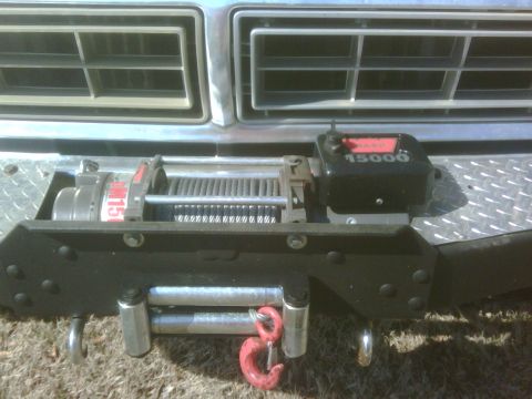 1978 Ford Bronco - Close-up of a vehicle's front bumper, a winch with visible "15000" markings.