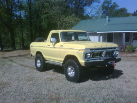 1978 Ford Bronco - A yellow 1978 Ford Bronco is shown from a three-quarter front angle in front of a house.