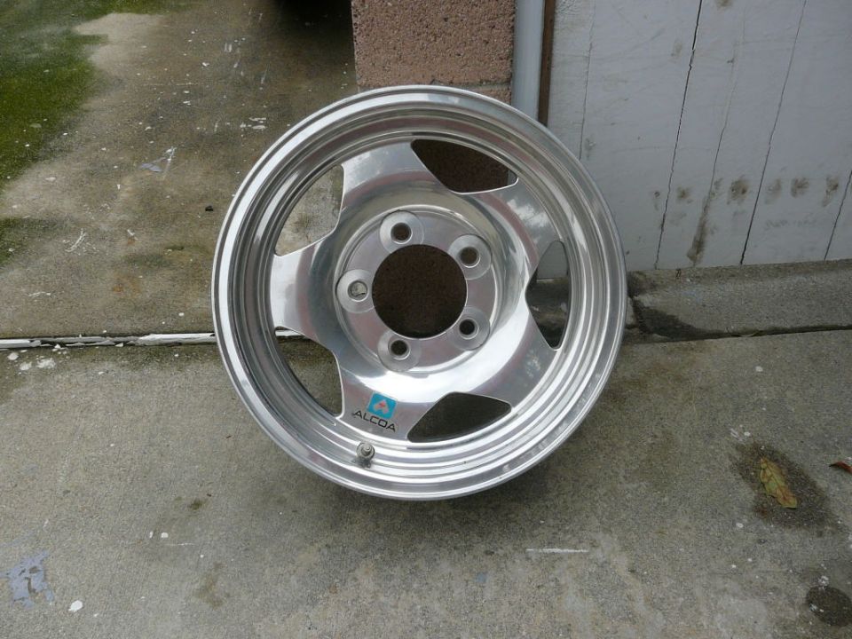 Alcoa aluminum wheel with five spokes and a blue logo