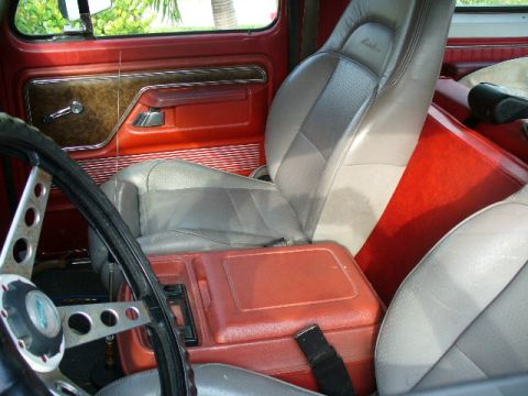 1995 Ford Bronco - Interior details of an older SUV, red upholstery and gray seats.