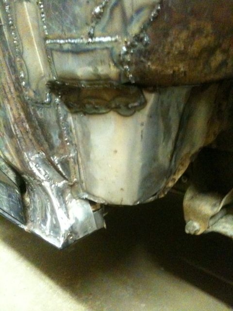 1993 Ford Bronco - Close-up view of welded metal repairs on a vehicle's frame, indicating rust repair work.