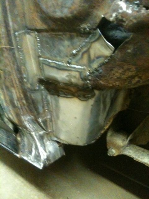 1993 Ford Bronco - This photo shows a section of a vehicle's frame that has been repaired with welded metal patches.