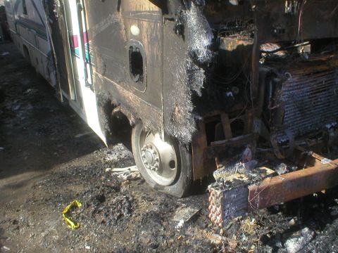 1998 GMC Sierra 3500 - This RV sustained significant fire damage, leaving its structure charred and components exposed.