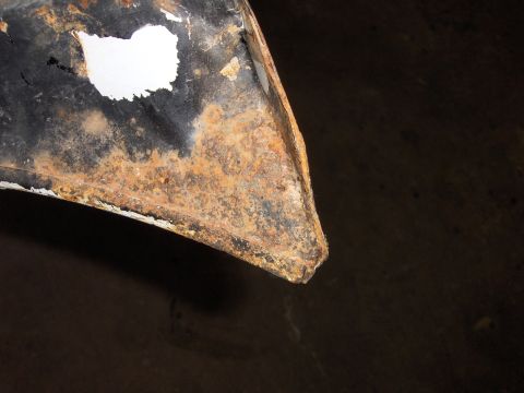 1980 Chevrolet Camaro - This image shows a close-up view of a heavily corroded metal part, likely from a vehicle's undercarriage.