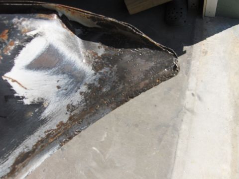 1980 Chevrolet Camaro - A close-up view of a damaged metal part, showing signs of rust and white paint.