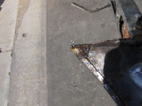 1980 Chevrolet Camaro - Metal part undergoing welding work on a concrete floor.