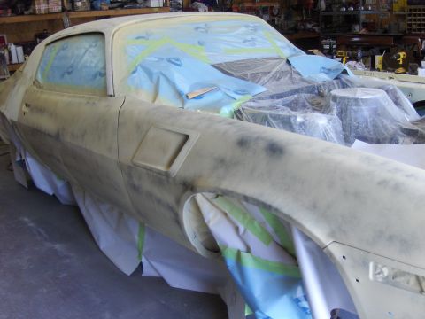 1980 Chevrolet Camaro - Car body in primer, taped off for paintwork, likely undergoing restoration.